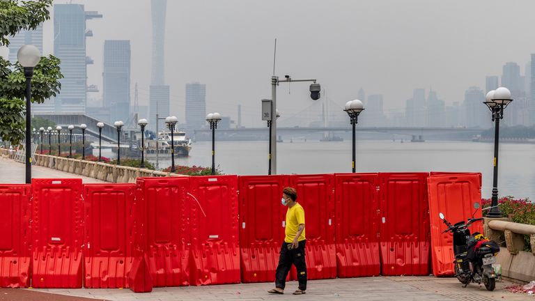 Un livreur à l’extérieur d’une zone de confinement Covid-19 attend que son client vienne chercher la livraison à Guangzhou, dans la province du Guangdong, dans le sud de la Chine, jeudi 17 novembre 2022. (FeatureChina via AP Images)